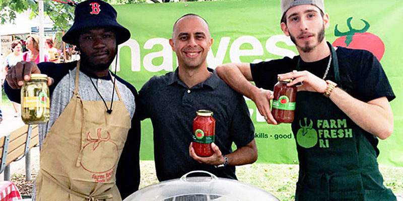 Photo of Mayor Jorge O. Elorza with Harvest Kitchen staff at their market stand