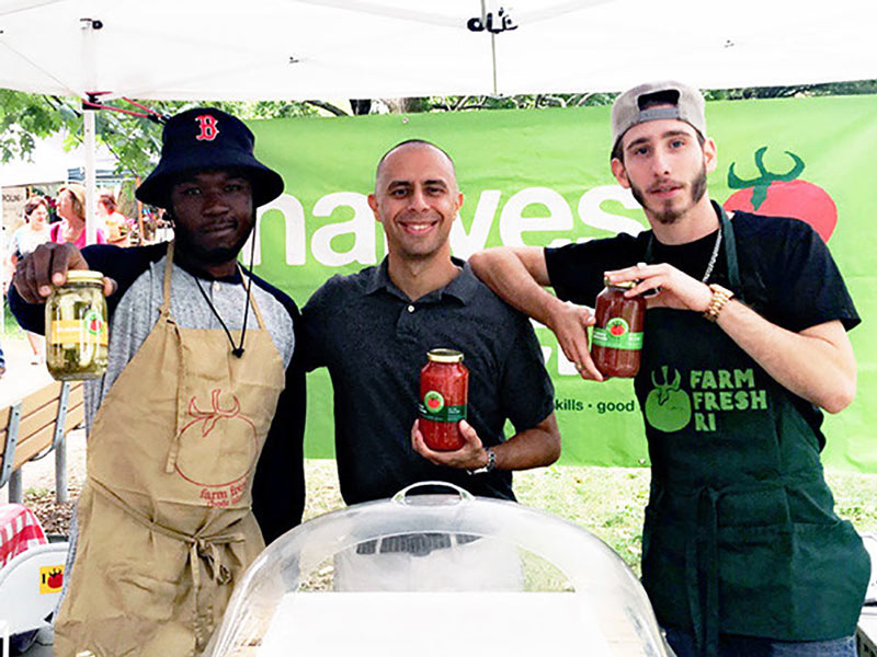 Photo of Mayor Jorge O. Elorza with Harvest Kitchen staff at their market stand